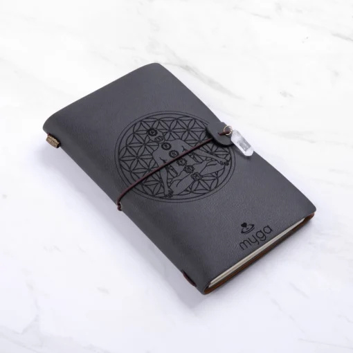 Sort notesbog med "Chakra" og klar Quartz krystal